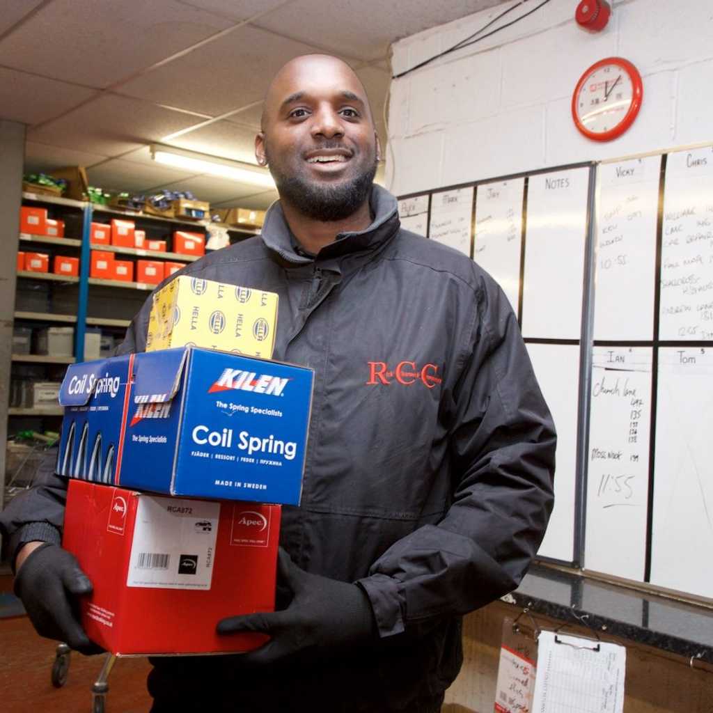  RCC driver holding boxes containing parts from multiple brands
